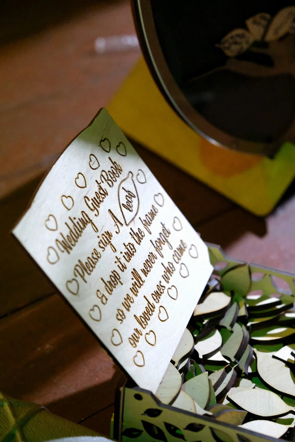 Engraved wooden wedding guest book sign, with heart pieces for guests to sign