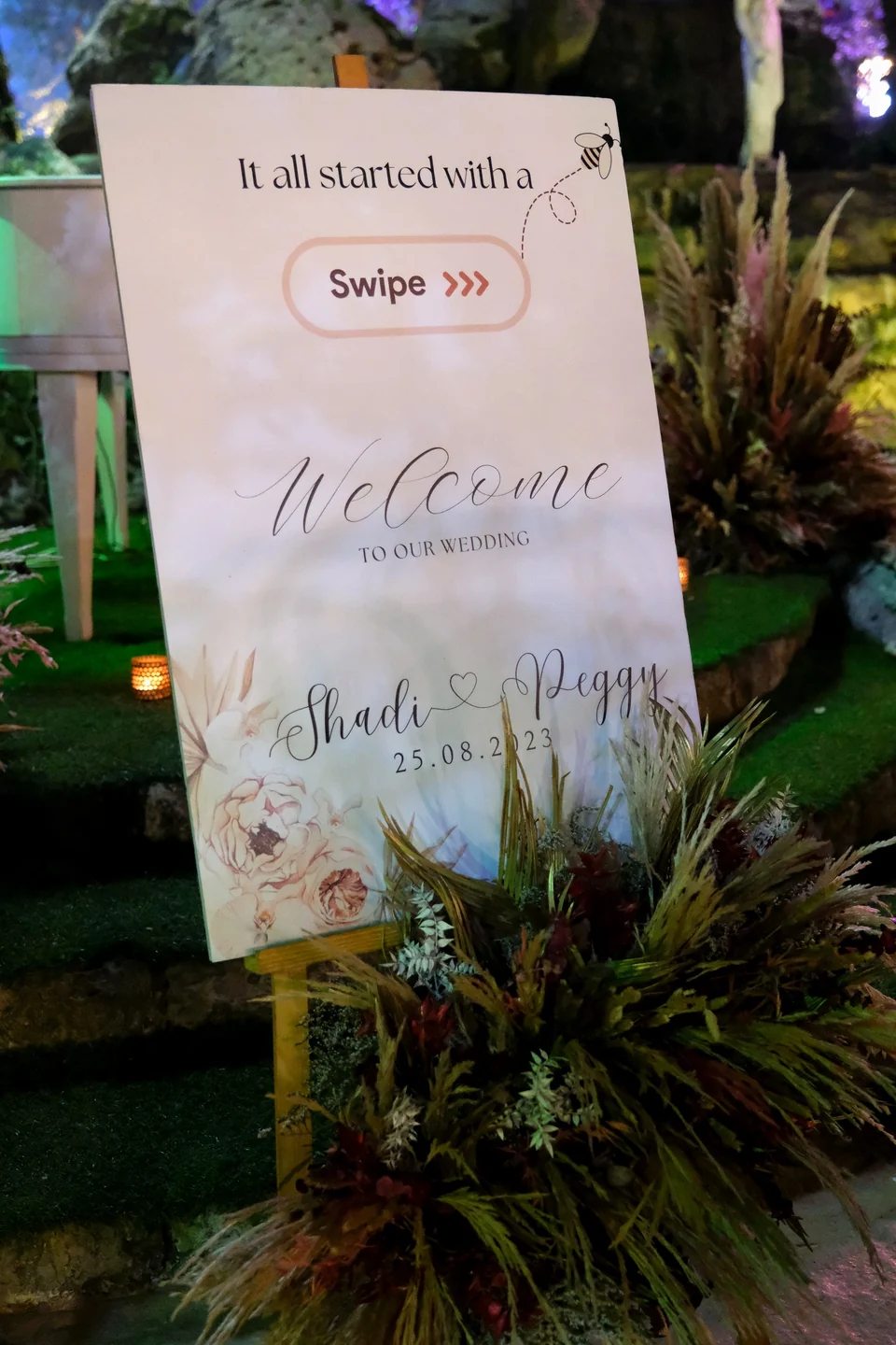 Personalised wedding welcome sign reading It All Started With a Swipe, with dried florals