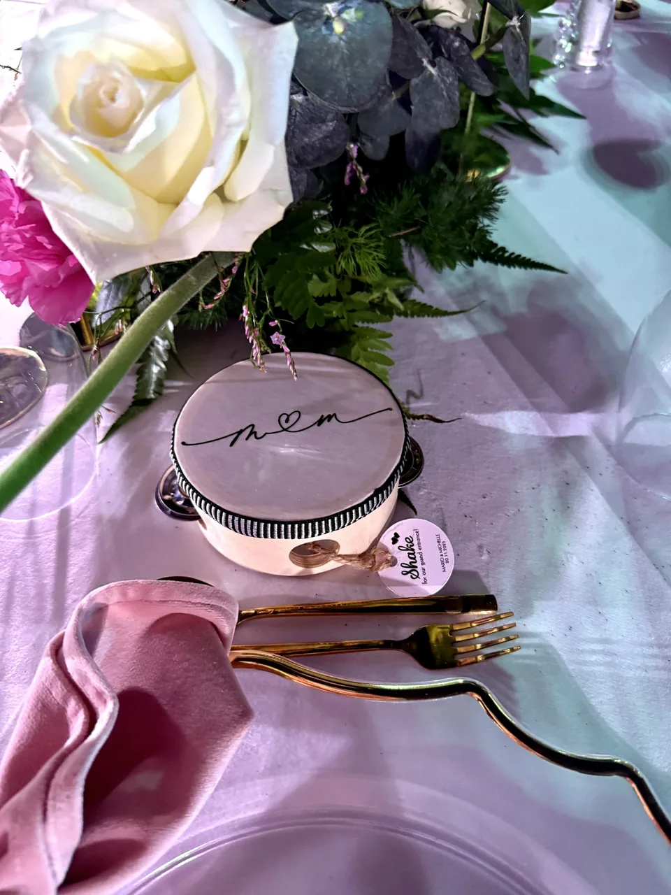 Personalised monogrammed keepsake at a wedding place setting with a white rose