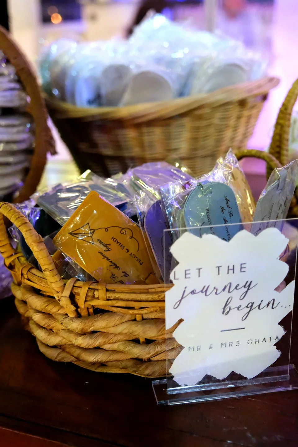 Basket of personalised wedding favours with a Let the Journey Begin sign