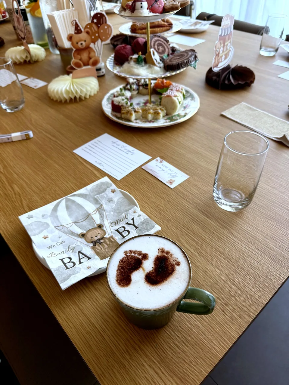 Baby shower brunch table with footprint latte, personalised Baby napkins, teddy bears and desserts