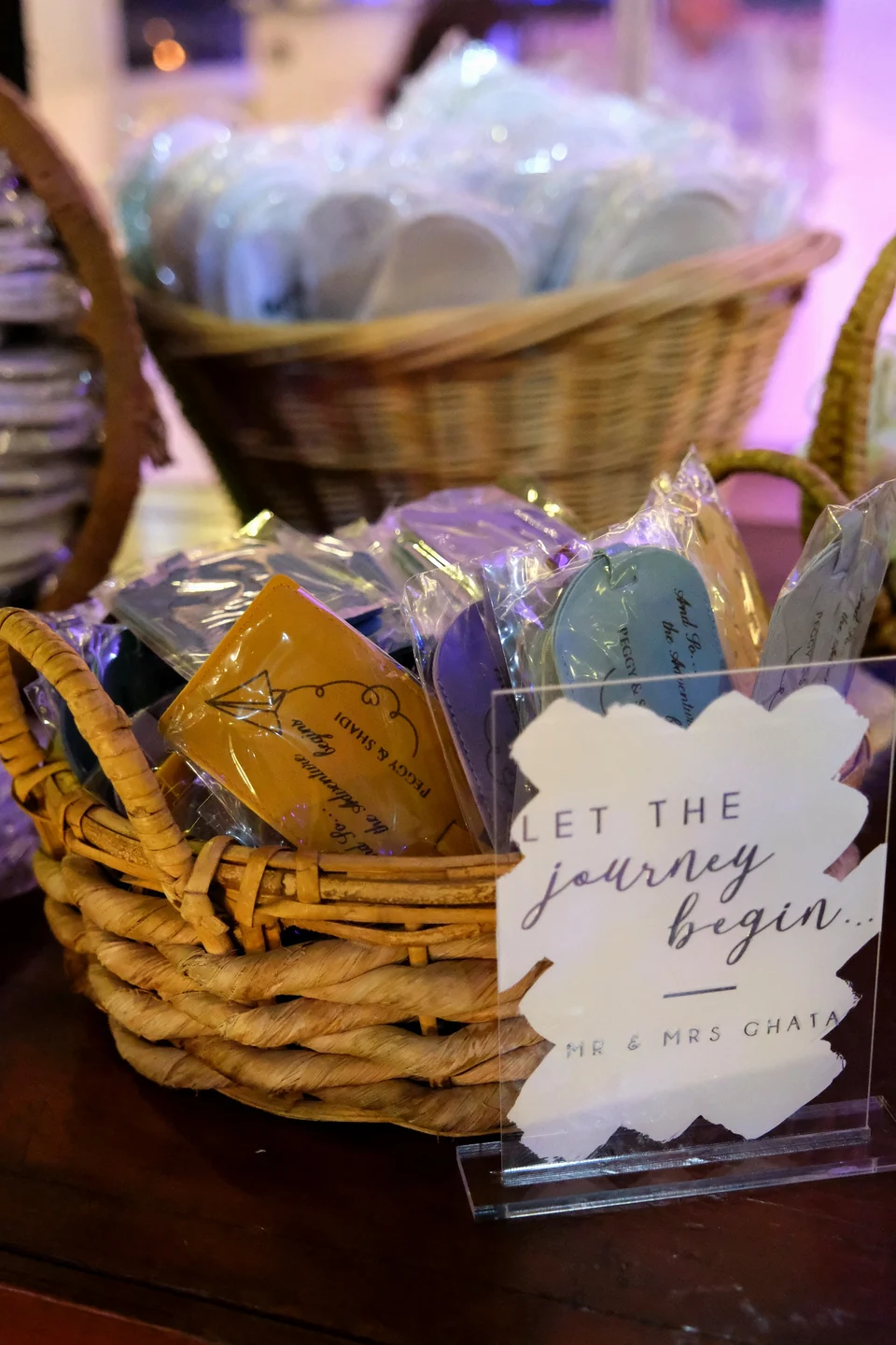 Baskets of wrapped favours with a Let the Journey Begin sign
