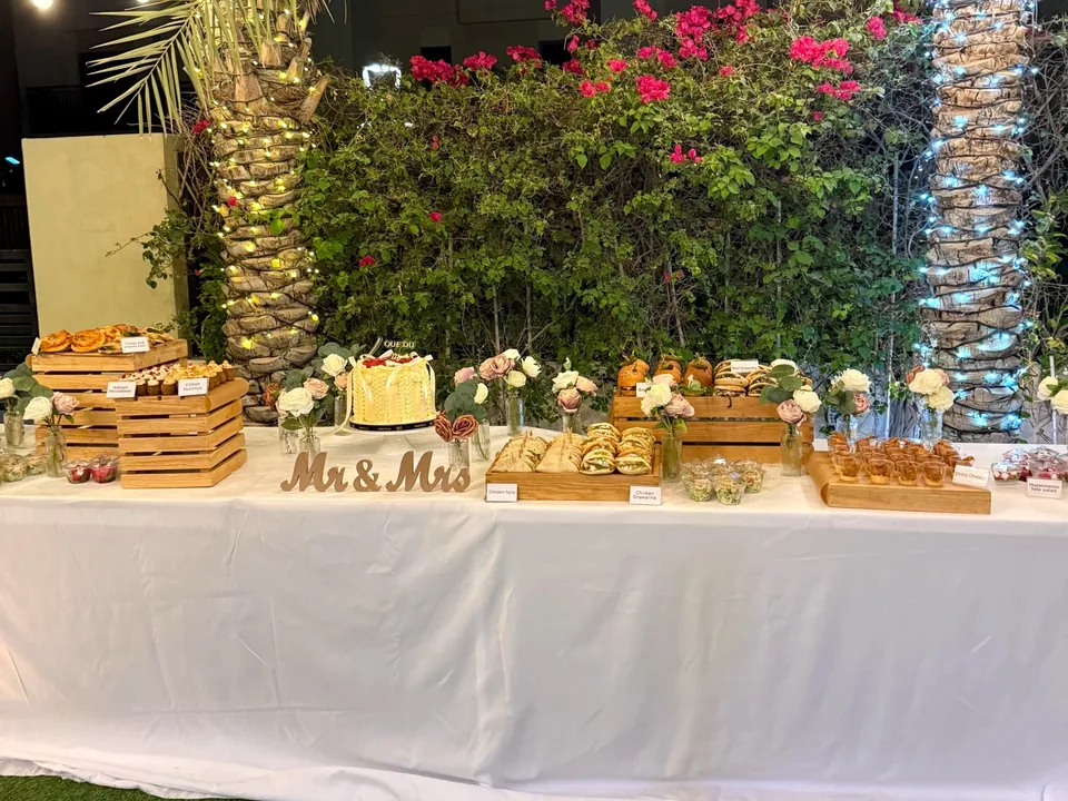 Civil celebration dessert table with wooden crates, a cake and a Mr & Mrs sign